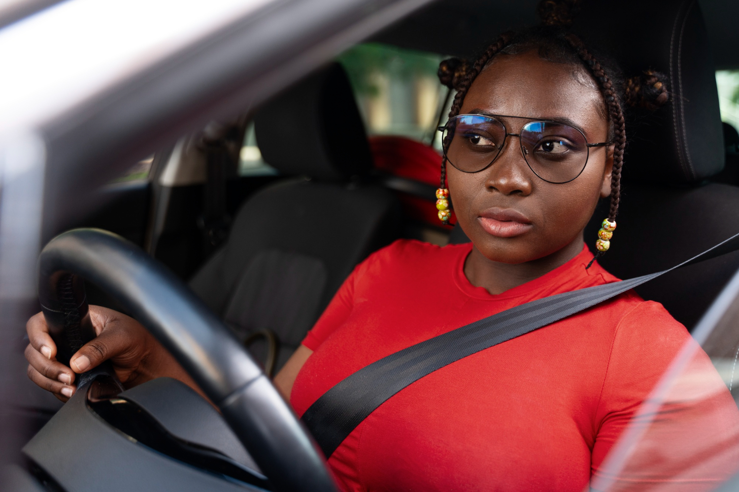 Confident driver with her seatbelt on at the wheel